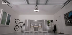 Modern garage with overhead door, bike rack, storage cabinets, and sports equipment organized neatly.