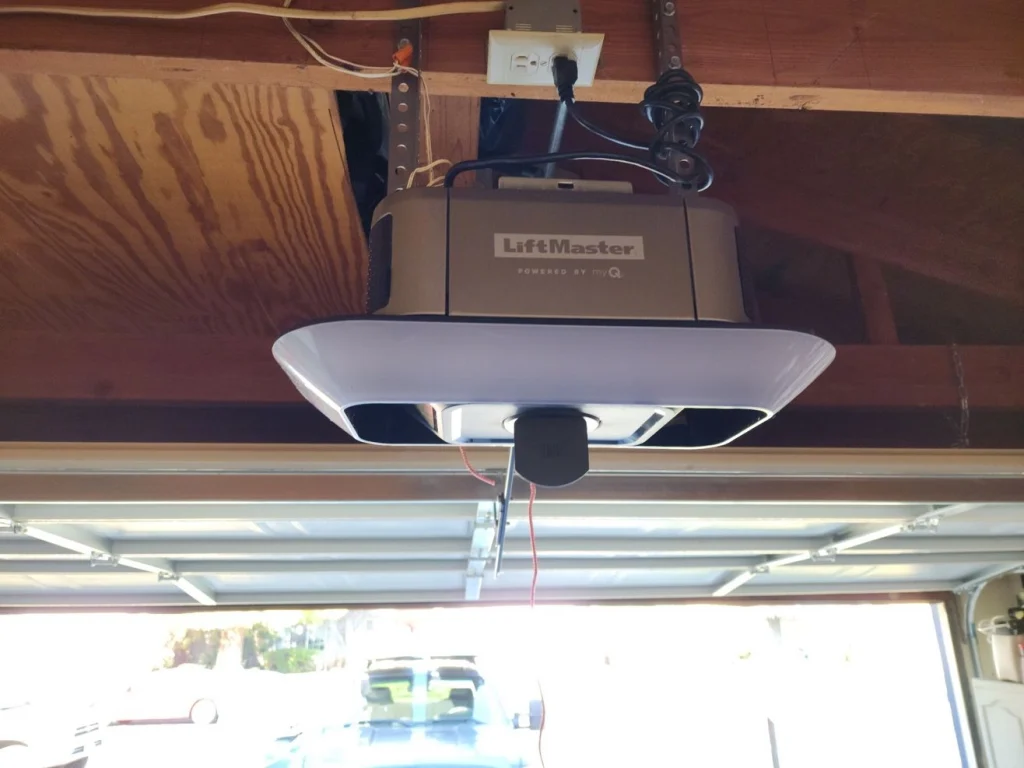Ceiling-mounted LiftMaster garage door opener in a residential garage.